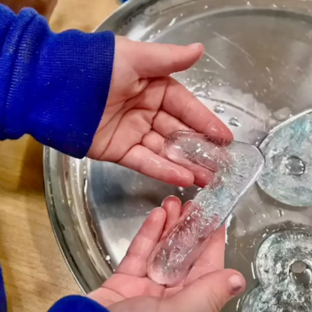 a child playing with numbers made from ice